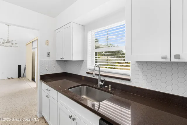 a kitchen with granite countertop a sink and a stove