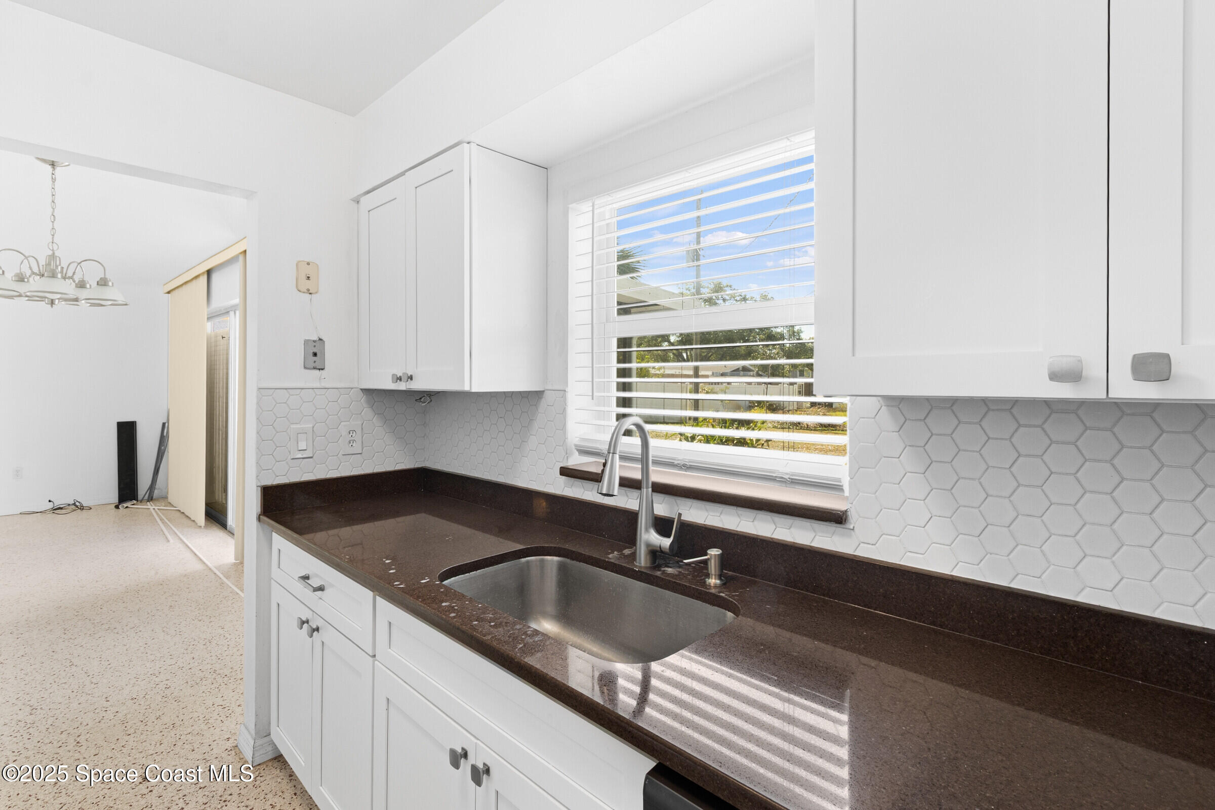 407 Bunker Street Melbourne, FL 32901 - Photo 13 of 26 a kitchen with granite countertop a sink and a stove