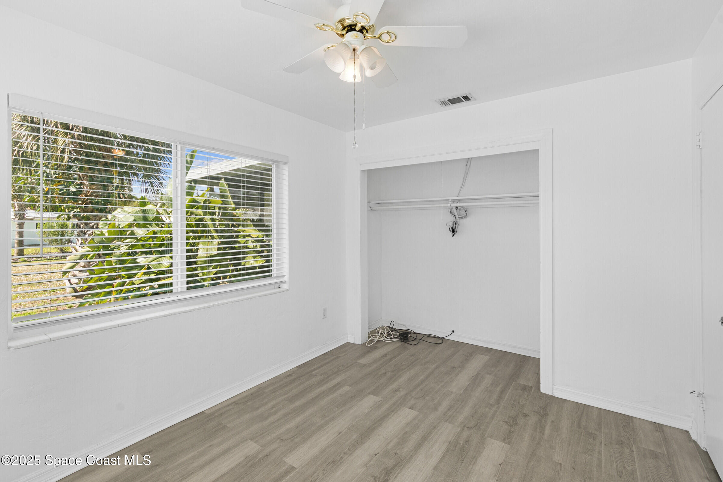 407 Bunker Street Melbourne, FL 32901 - Photo 18 of 26 a view of a livingroom with a chandelier fan and wooden floor