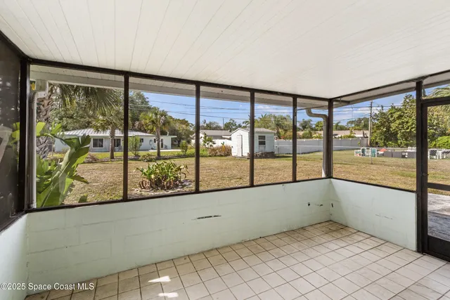 an empty room with large windows