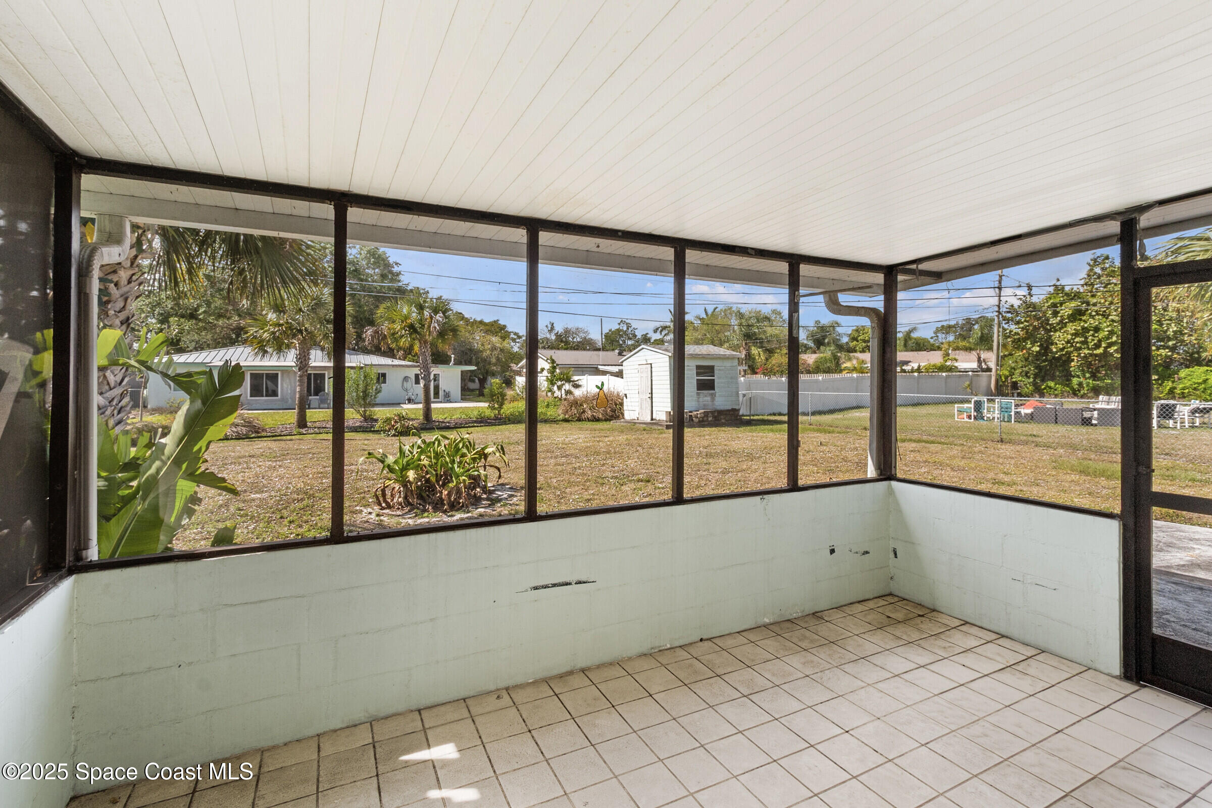 407 Bunker Street Melbourne, FL 32901 - Photo 25 of 26 an empty room with large windows
