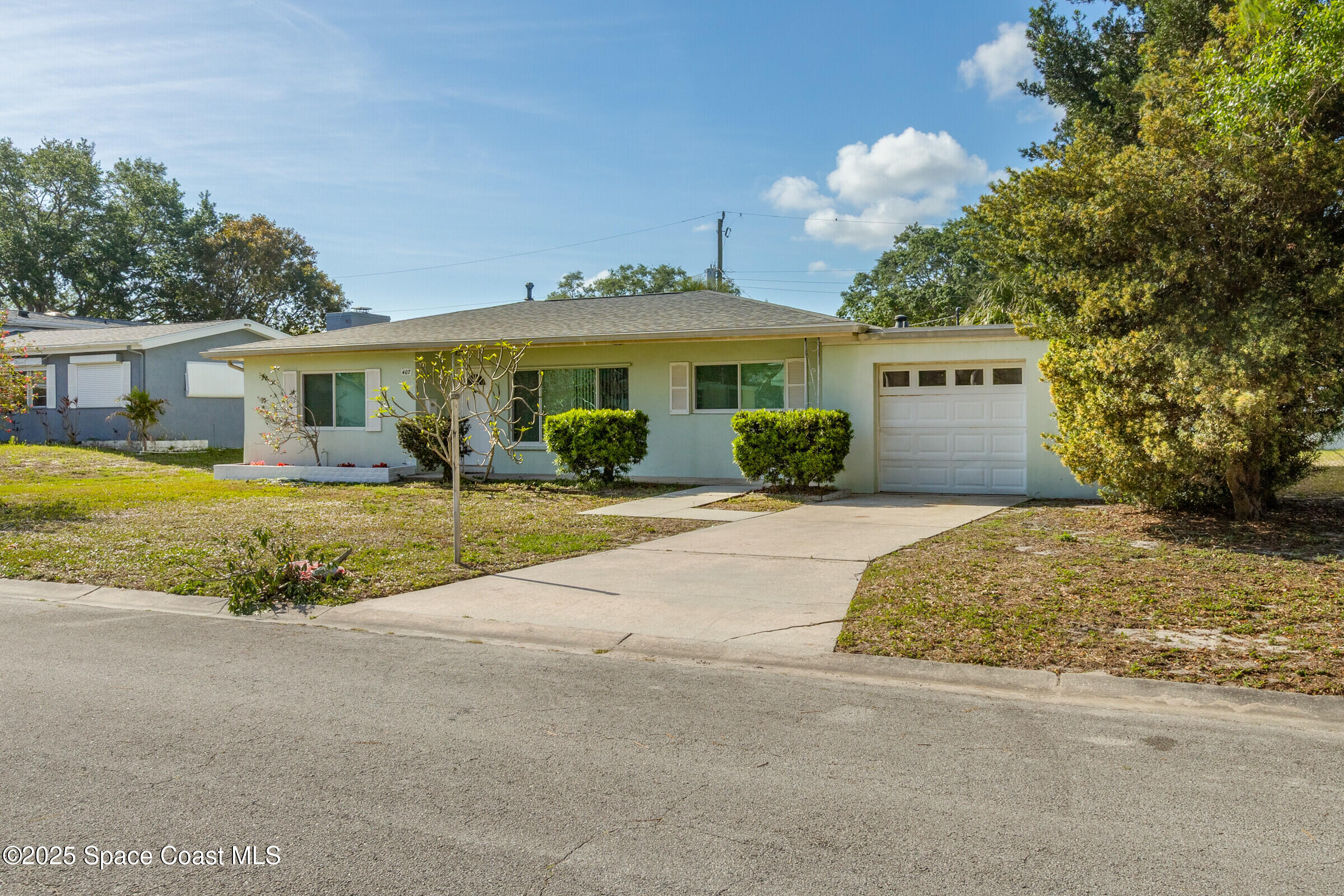407 Bunker Street Melbourne, FL 32901 - Photo 3 of 26 a front view of a house with a yard and potted plants