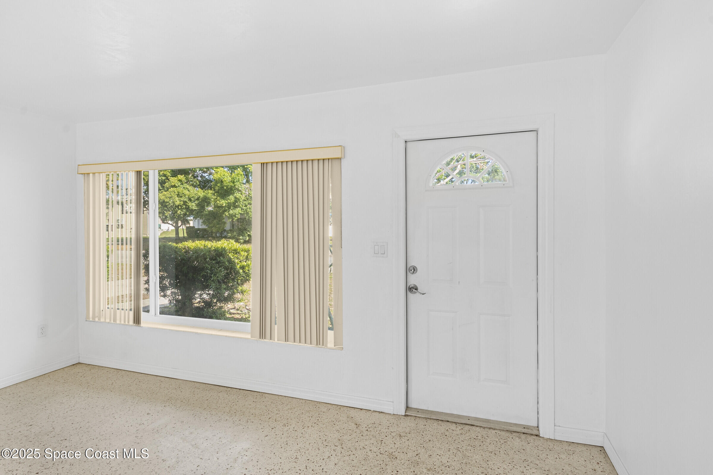 407 Bunker Street Melbourne, FL 32901 - Photo 6 of 26 an empty room with windows