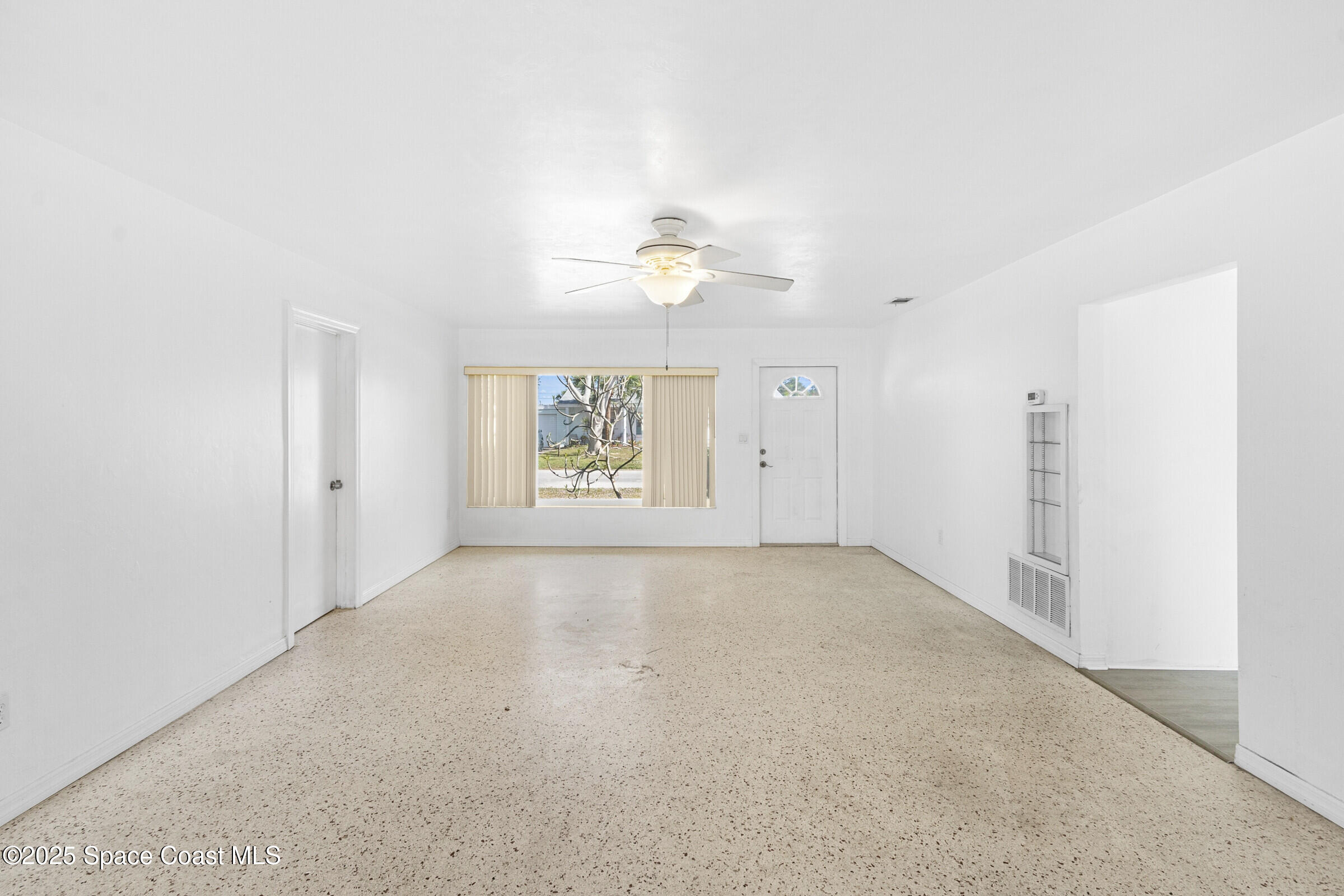 407 Bunker Street Melbourne, FL 32901 - Photo 8 of 26 an empty room with windows and fan