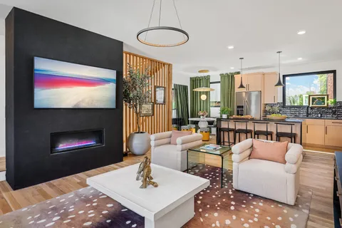 a living room with furniture a fireplace and a flat screen tv