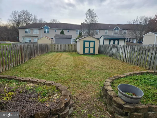a view of a house with backyard and porch