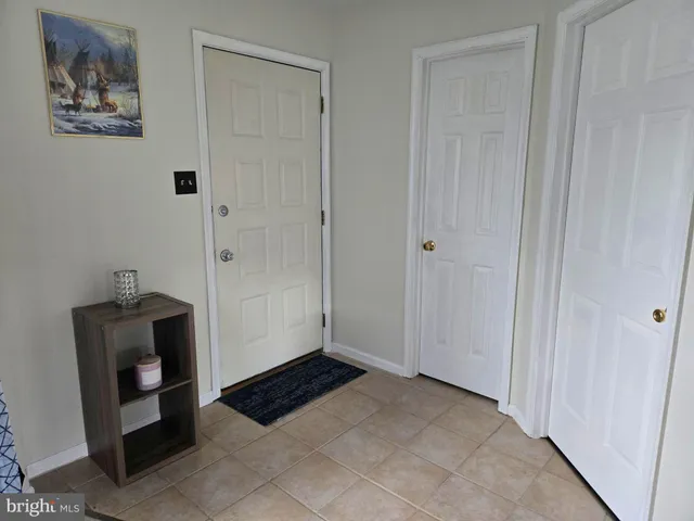 a view of a closet area with hardwood floor
