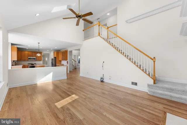 a view of a livingroom with wooden floor and staircase