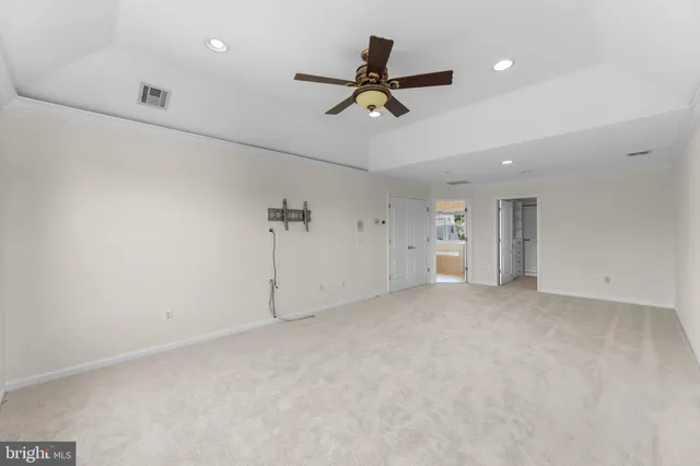 a view of a livingroom with a ceiling fan and window