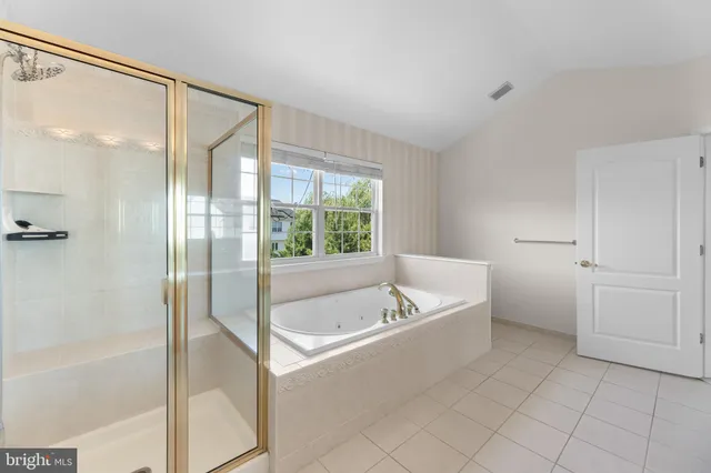 a spacious bathroom with a bathtub and a shower