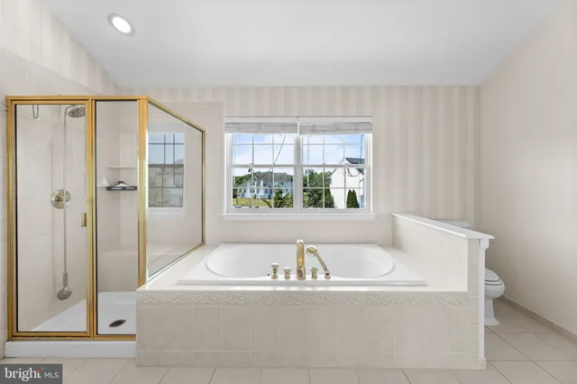 a bath tub sitting in a bathroom next to a window