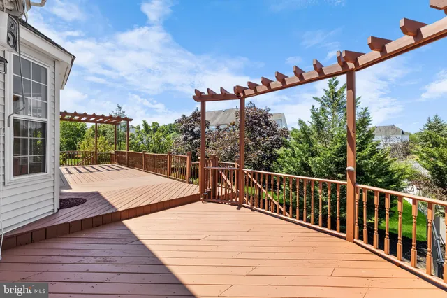 a view of a balcony with wooden floor and fence