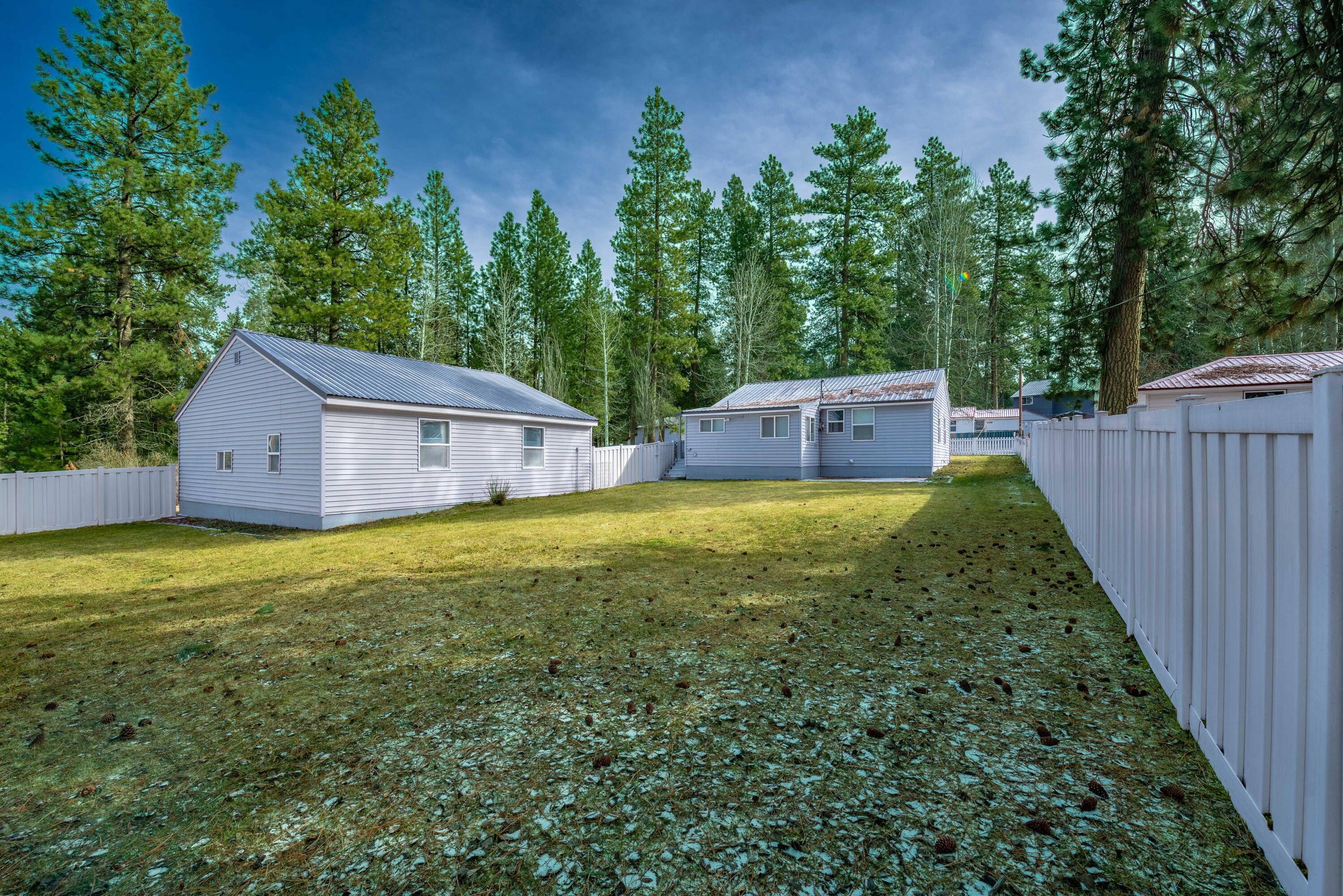 138722 Rhododendron Street Gilchrist, OR 97737 - Photo 8 of 36 a view of house with backyard and trees