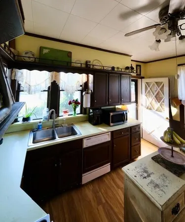 a kitchen with a sink appliances and cabinets