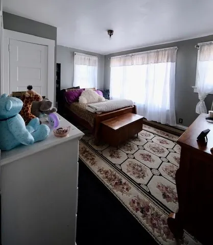 a bedroom with bed and window