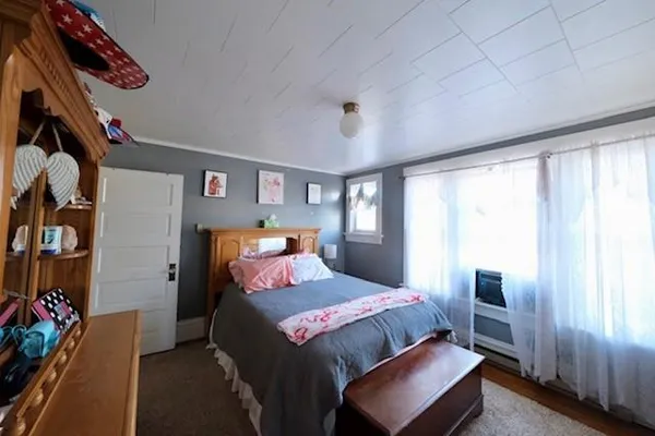 a bedroom with a bed and a window