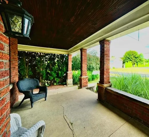 a balcony with furniture and a potted plant