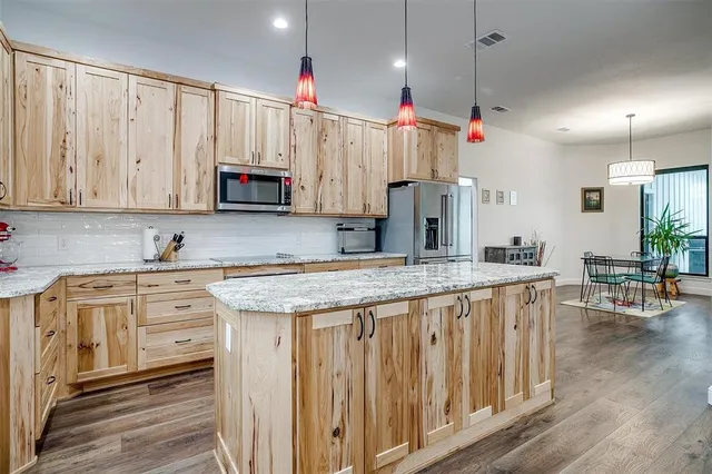 a kitchen that has a lot of cabinets in it