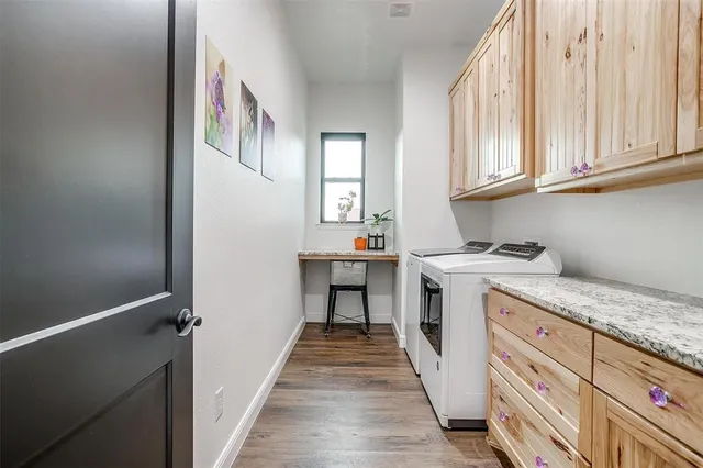 a storage room with granite countertop a sink and dishwasher a stove with wooden floor