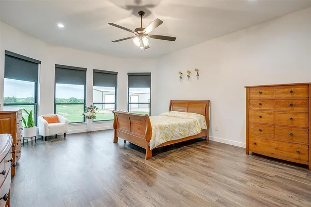 a bedroom with a large bed a chandelier and a couch