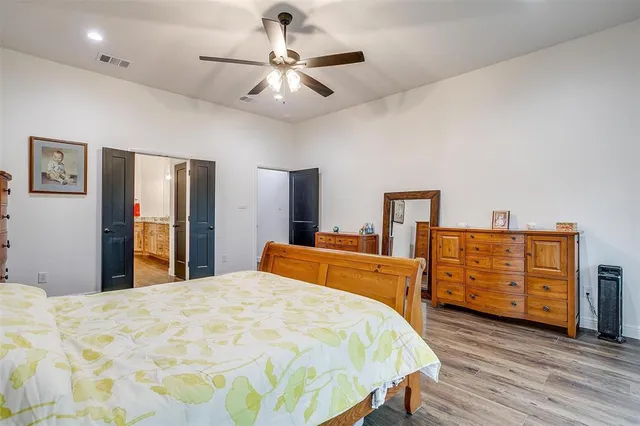 a bedroom with bed and wooden floor