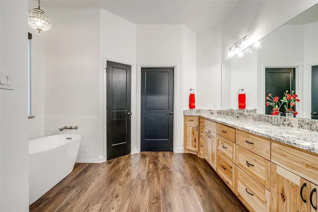 a bathroom with double sink and a mirror