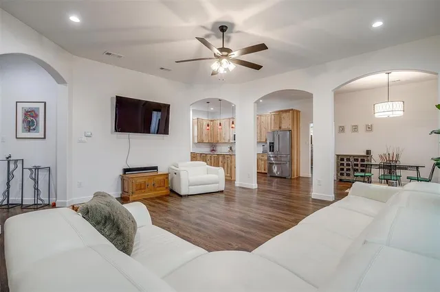 a bedroom with furniture and a flat screen tv