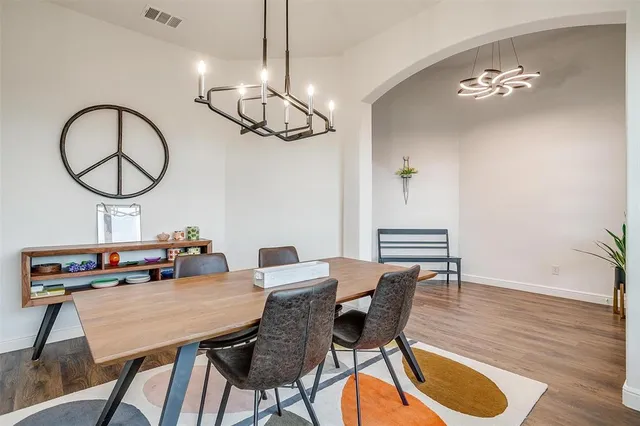 a view of a dining room with furniture wooden floor and chandelier