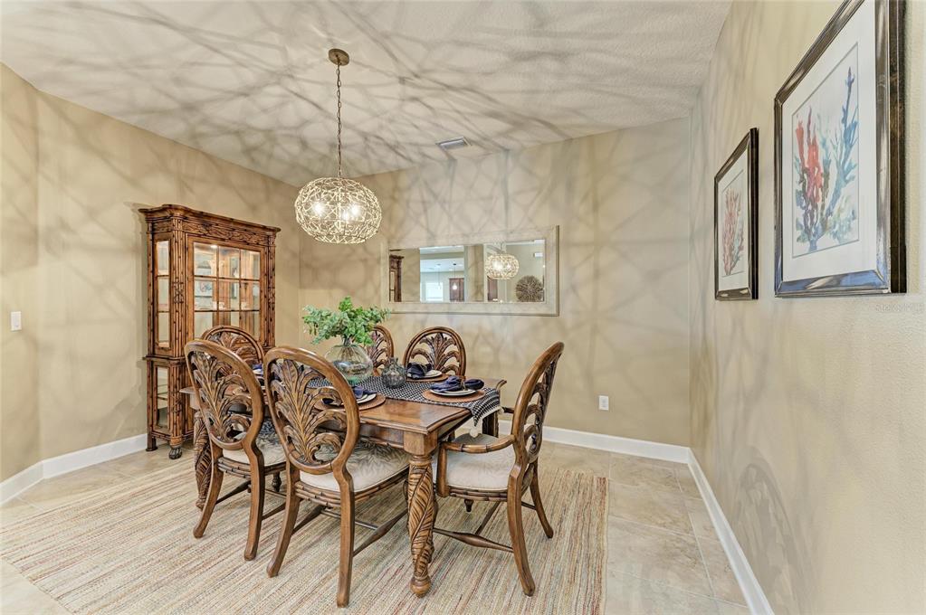 5307 65th Terrace East Ellenton, FL 34222 - Photo 11 of 47 a view of a dining room with furniture window and wooden floor