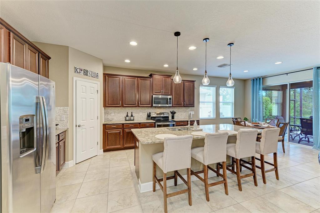 5307 65th Terrace East Ellenton, FL 34222 - Photo 16 of 47 a large kitchen with a table and chairs
