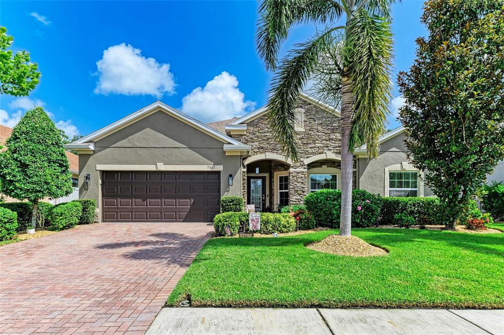 5307 65th Terrace East Ellenton, FL 34222 - Photo 2 of 47 front view of a house with a yard