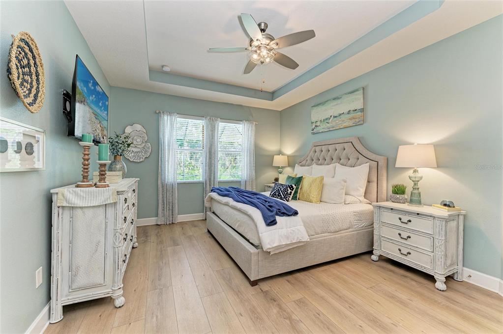5307 65th Terrace East Ellenton, FL 34222 - Photo 30 of 47 a bedroom with a bed and a chandelier