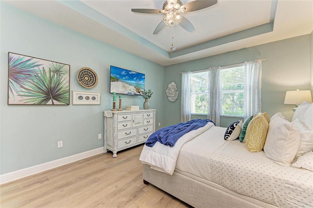 5307 65th Terrace East Ellenton, FL 34222 - Photo 31 of 47 a bedroom with a bed and a chandelier