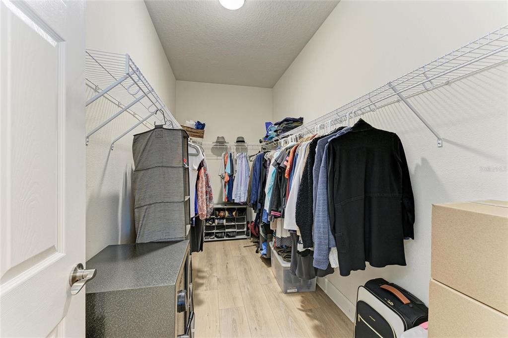 5307 65th Terrace East Ellenton, FL 34222 - Photo 35 of 47 a view of walk in closet with clothes and shoes