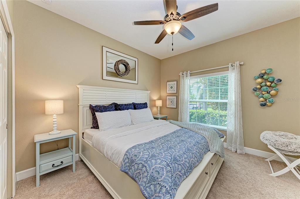5307 65th Terrace East Ellenton, FL 34222 - Photo 36 of 47 a bedroom with a bed and a chandelier