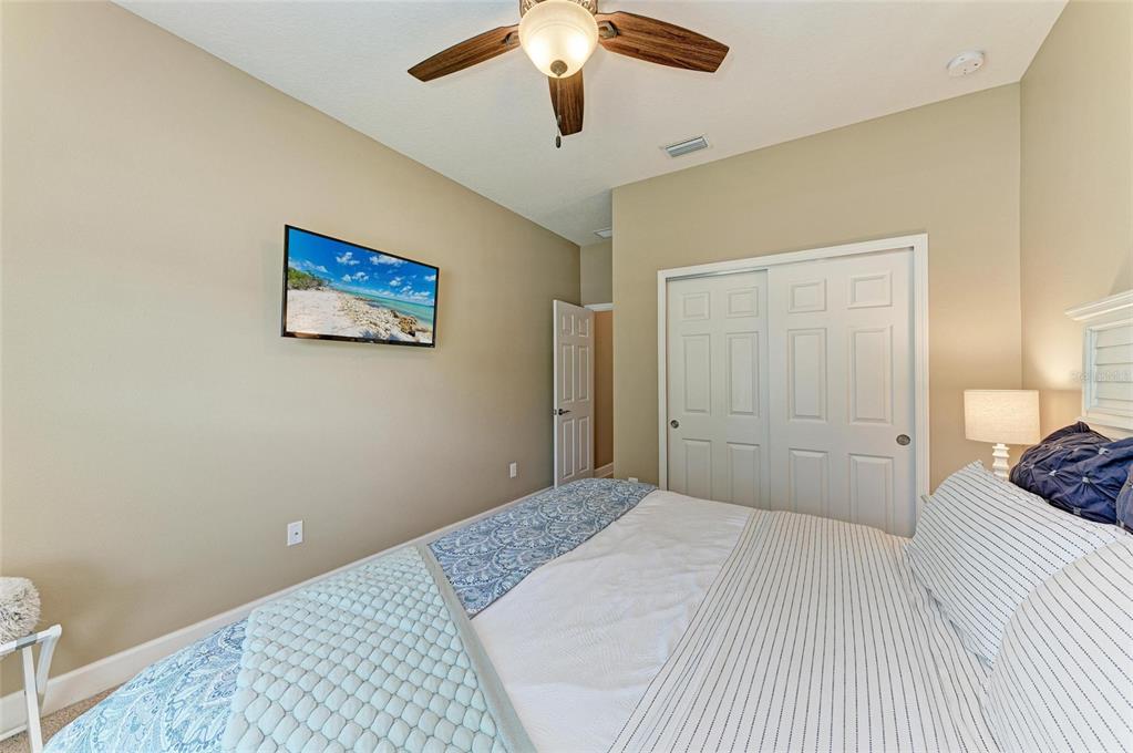 5307 65th Terrace East Ellenton, FL 34222 - Photo 37 of 47 a bedroom with a bed and a chandelier
