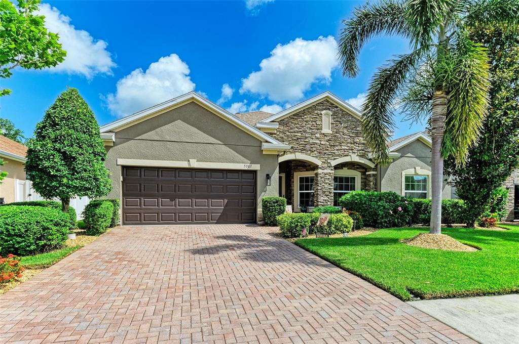 5307 65th Terrace East Ellenton, FL 34222 - Photo 5 of 47 a front view of a house with a yard