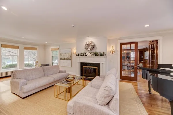 a living room with furniture and a chandelier