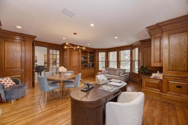 a living room with furniture and a chandelier