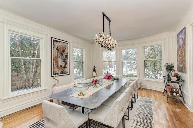 a kitchen with granite countertop a sink stove and wooden floor