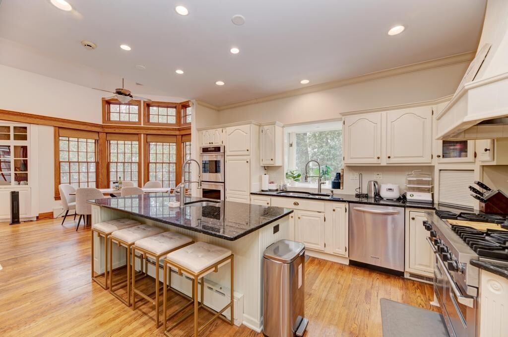 1499 Sheridan Road Highland Park, IL 60035 - Photo 23 of 84 a kitchen with stainless steel appliances granite countertop a stove top oven a sink a dining table and chairs