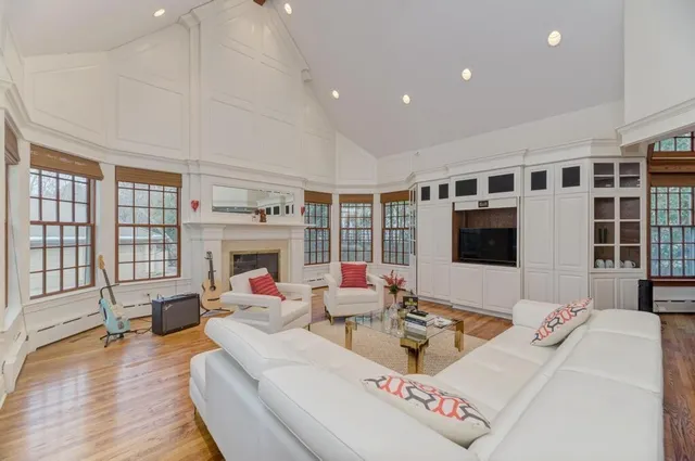 a living room with a rug and a wooden floor