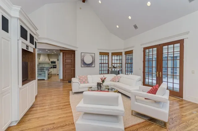 a spacious bedroom with a bed and a large mirror