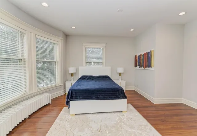 a bedroom with a bed and a chair