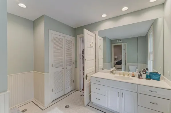 a view of a bedroom with wooden floor and stairs