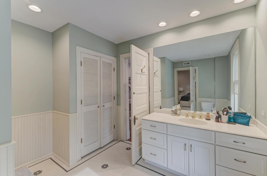 1499 Sheridan Road Highland Park, IL 60035 - Photo 44 of 87 a bathroom with a shower sink and mirror