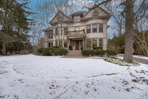 a living room with furniture a fireplace and a large window