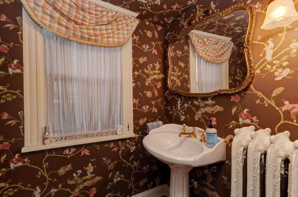 1499 Sheridan Road Highland Park, IL 60035 - Photo 10 of 87 a bathroom with a sink and a mirror