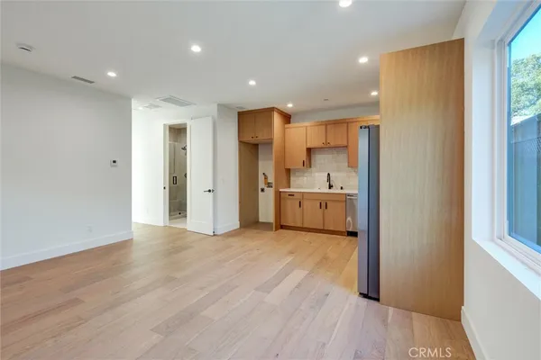 a view of a kitchen with a sink and a refrigerator