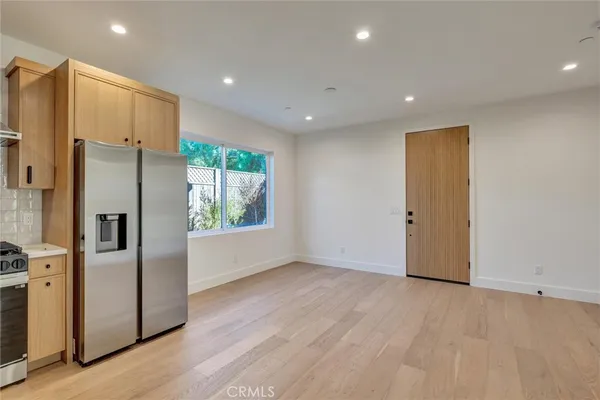 a kitchen with stainless steel appliances a refrigerator and a stove top oven